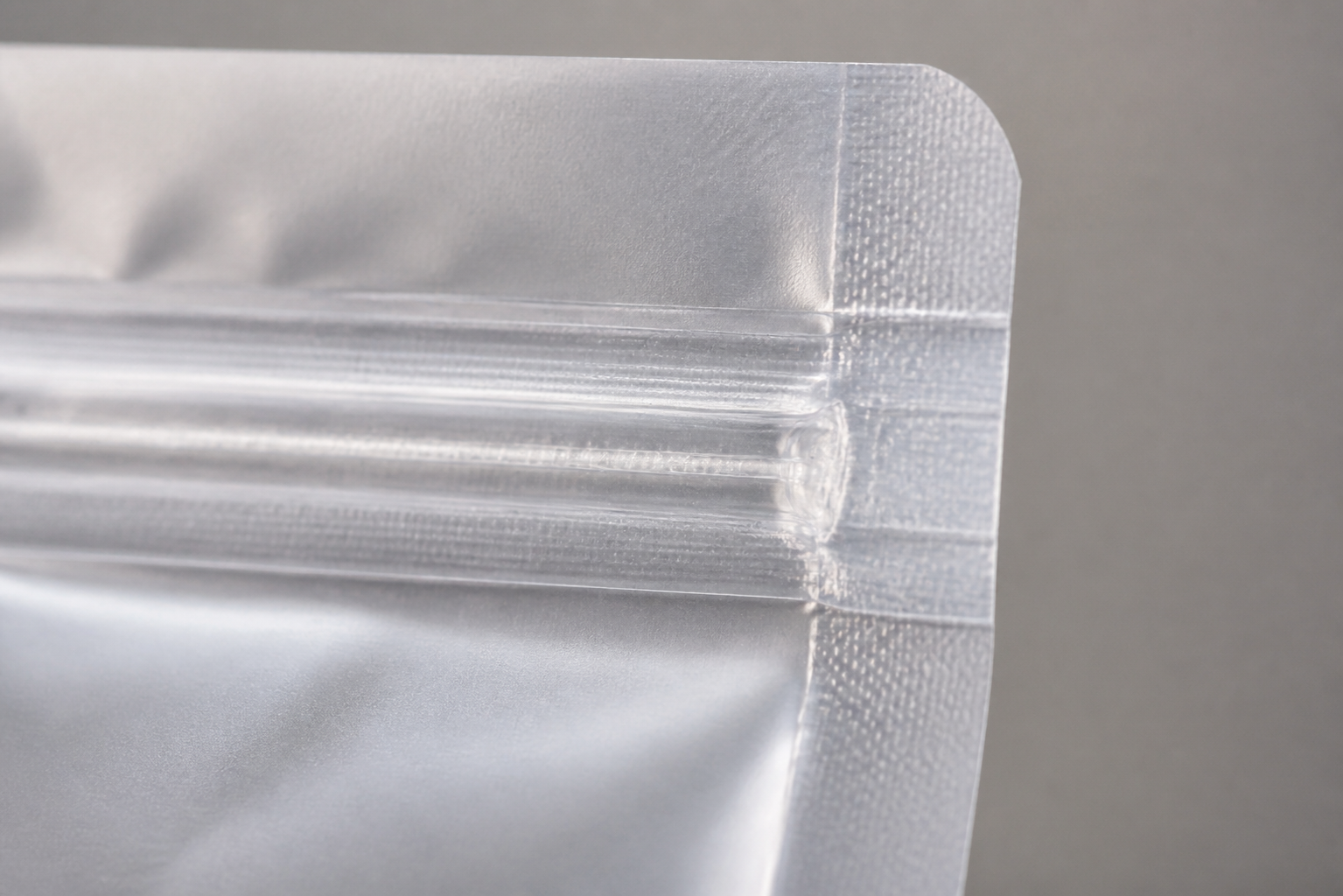 Zipper End Seal Detail Close view of a zipper pouch side seal showing the zipper end captured in the sealed edge.