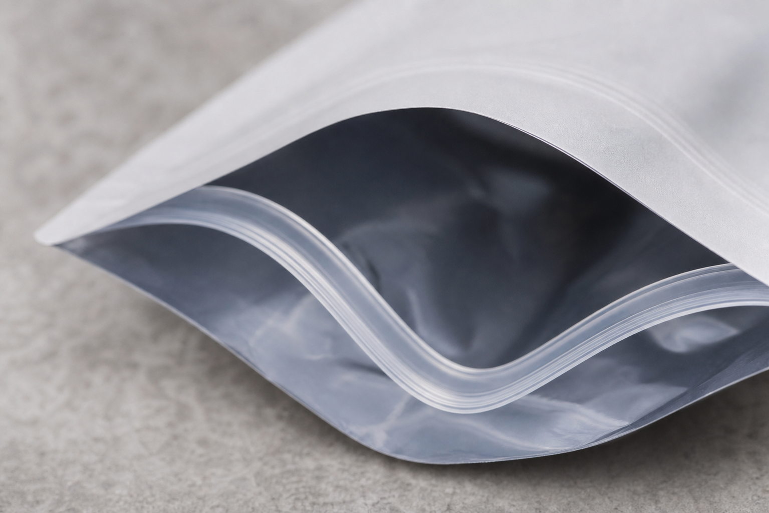 Reclosable Pouch Film Structure Close view of an unbranded flexible zipper pouch showing the reclosure profile and film edge.