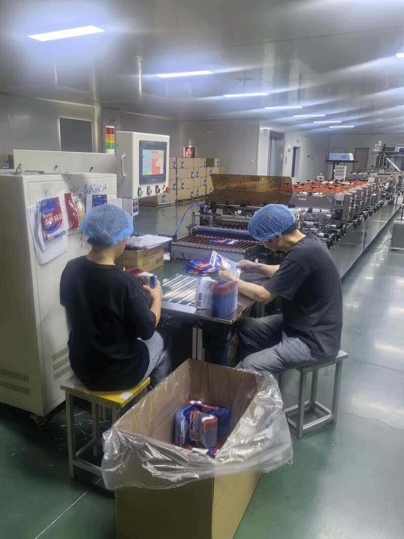 Factory worker on the pouch production line